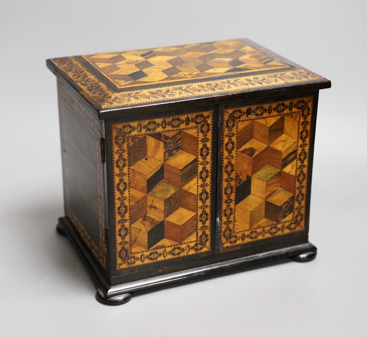 A 19th century Tunbridge ware specimen cube marquetry and coromandel table cabinet, label to underside reads ‘T.Barton, Late NYE, Manufacturer, Mount Ephraim and Parade, Tunbridge Wells’, 18cm tall